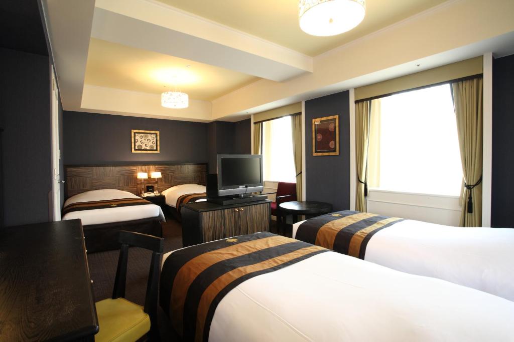 Postel nebo postele na pokoji v ubytování Hotel Monterey Kyoto