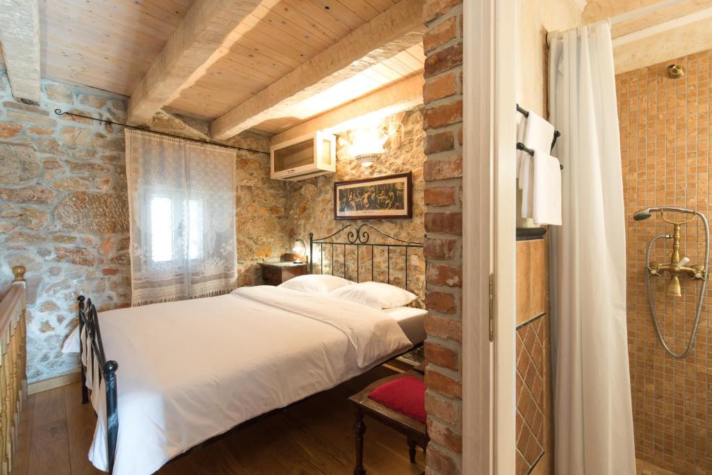 a bedroom with a bed in a brick wall at Holiday Home Bozanić in Vrbnik