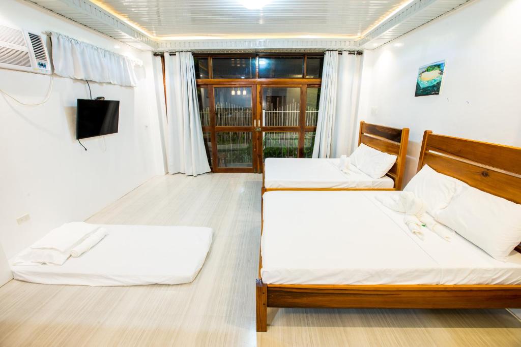 Postel nebo postele na pokoji v ubytování Siargao Home Sweet Home