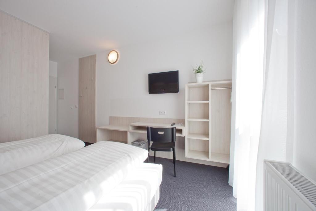 Postel nebo postele na pokoji v ubytování Motel Hohenems