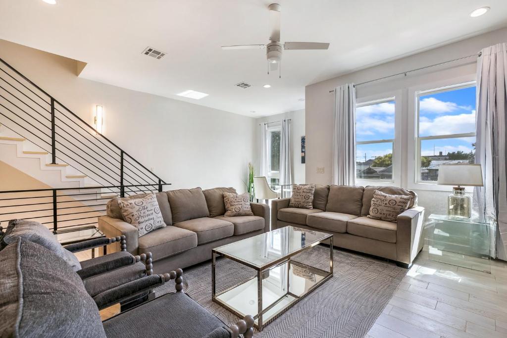 a living room with a couch and a table at New Construction Townhouse Near City Hot Spots in New Orleans