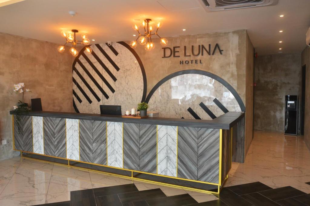 a lobby of a luxury hotel with a reception desk at De Luna Hotel Sri Petaling in Kuala Lumpur