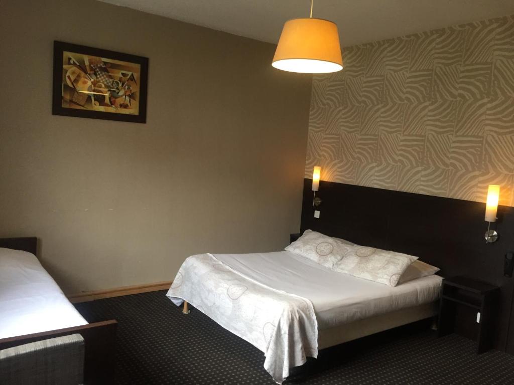 Postelja oz. postelje v sobi nastanitve Hotel Restaurant Cousseau