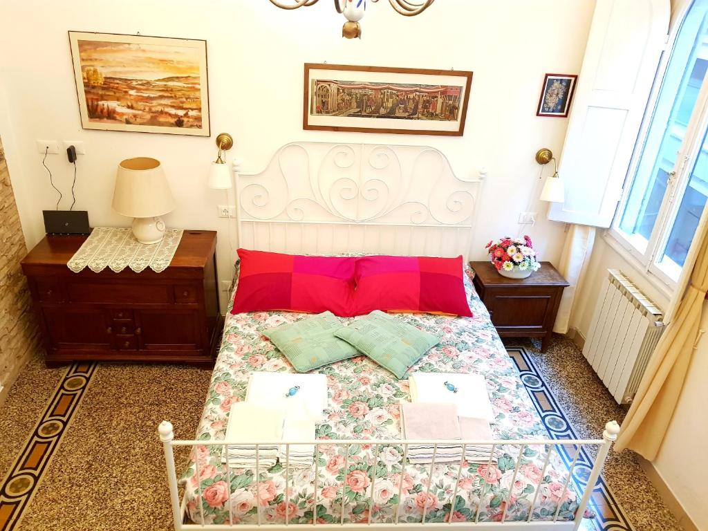 a bedroom with a large bed with red pillows at Florence Signoria Apartment in Florence