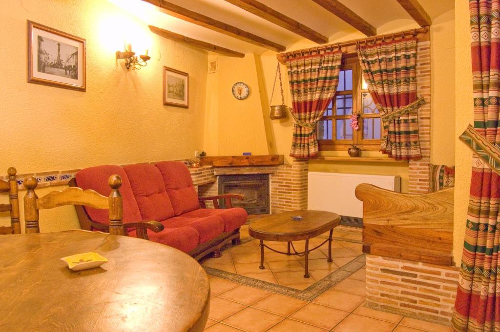 a living room with a couch and a fireplace at Torrefolch in Forcall