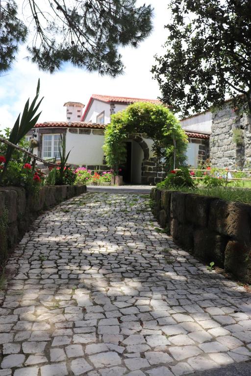 a cobblestone driveway in front of a house at Quinta da Espadana in Povoação