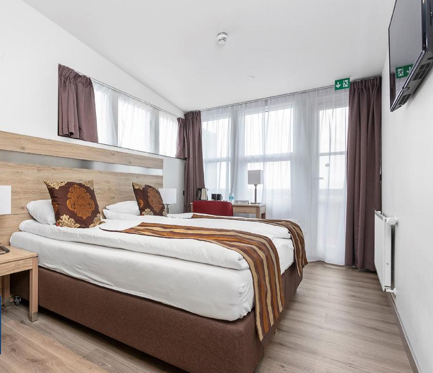 Postel nebo postele na pokoji v ubytování Hotel Duus by Keflavik Airport