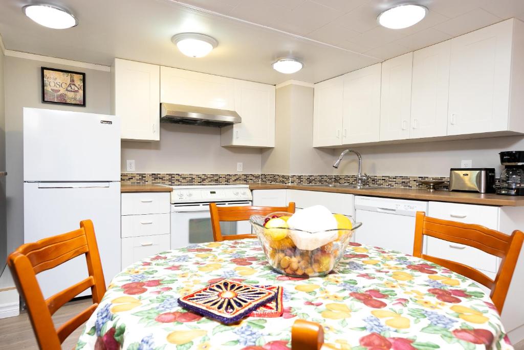a kitchen with a table with a bowl of fruit on it at Lily's garden in Charlottetown