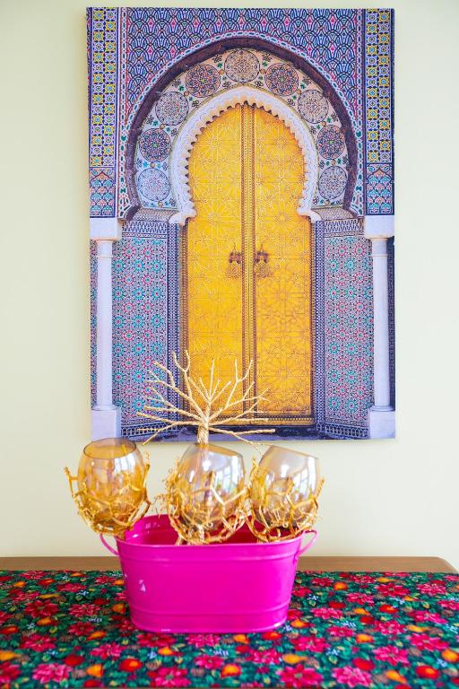 a pink bowl with a plant in front of a door at Lily's garden in Charlottetown