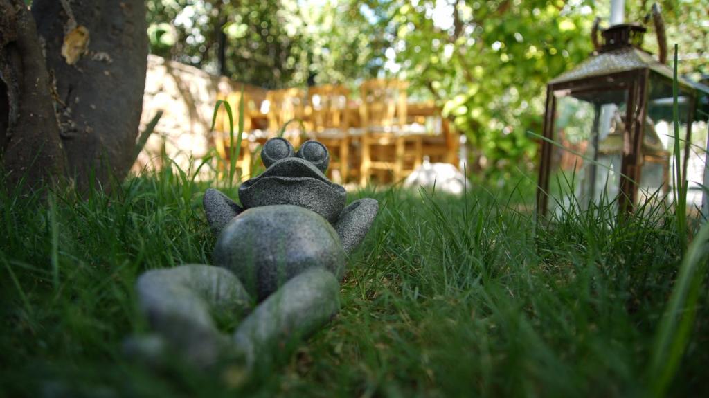 a teddy bear laying in the grass in the yard at L'onda Oda Bodrum in Bodrum City