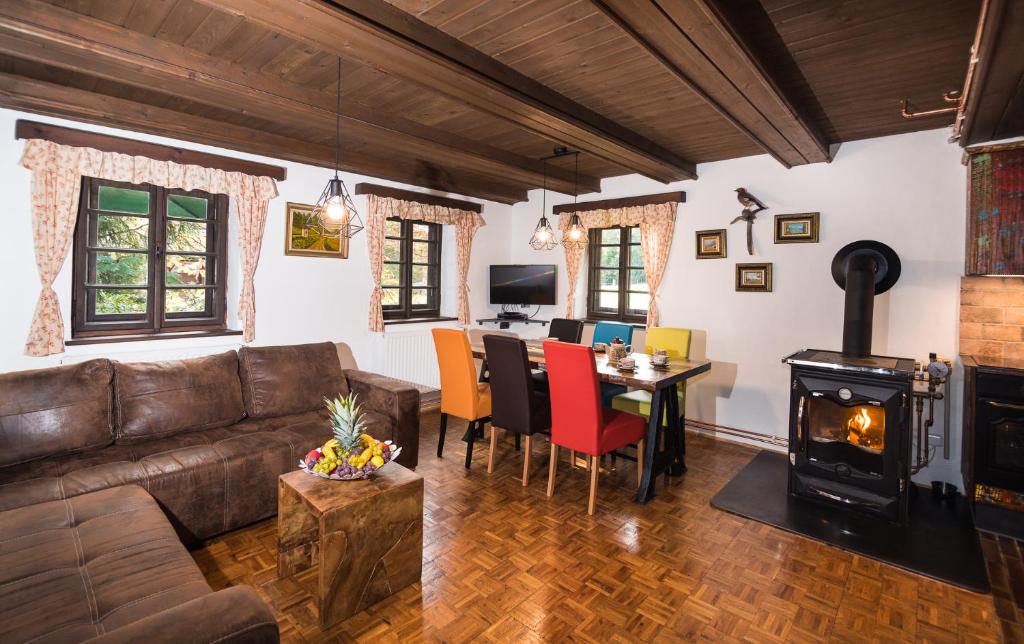 a living room with a couch and a wood stove at Vacation house KURTOVEC in Benešov nad Černou