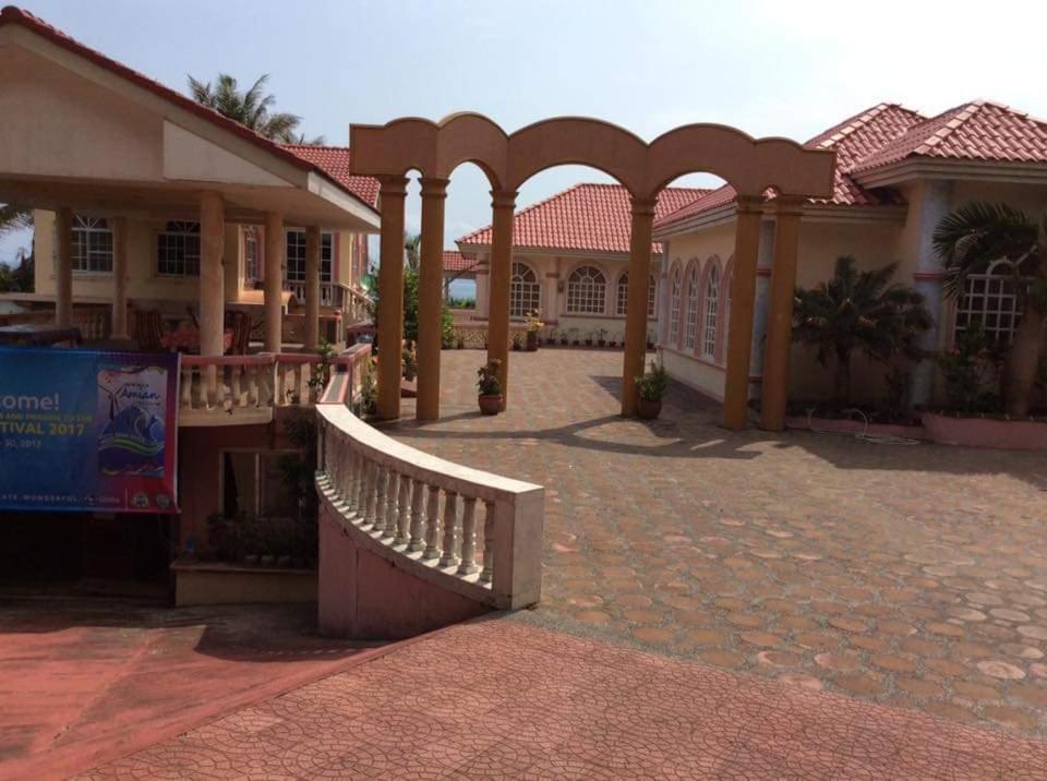 a building with a bridge in the middle of a courtyard at Amerie Rae Resorts in Bangui