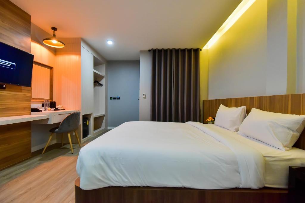 Postel nebo postele na pokoji v ubytování U Rip Resort Phi Phi Hotel
