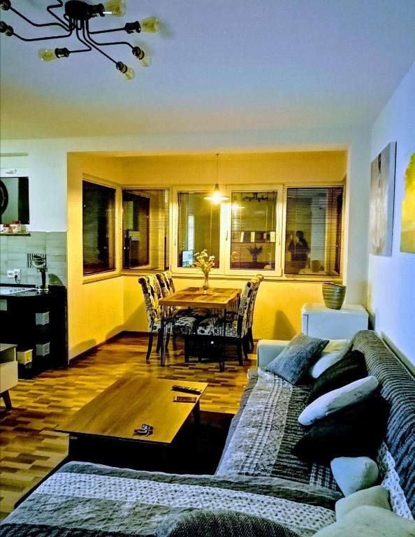 a living room with a couch and a table at Apartman EDEN No 1 in Teslić