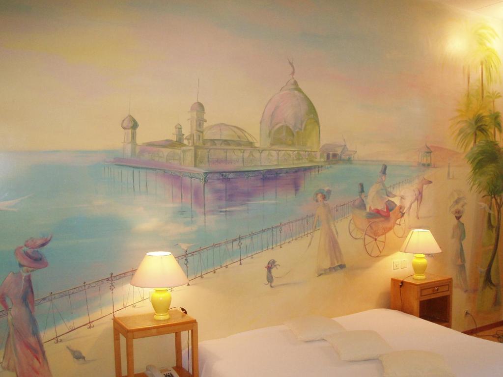 a bedroom with a mural of a beach at Le Windsor, Jungle Art Hotel in Nice