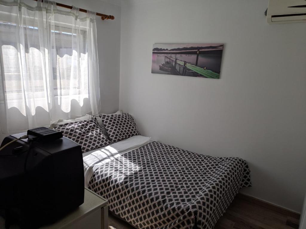 a bedroom with two twin beds and a television at Sky line center city Dimitropoulos in Aigio