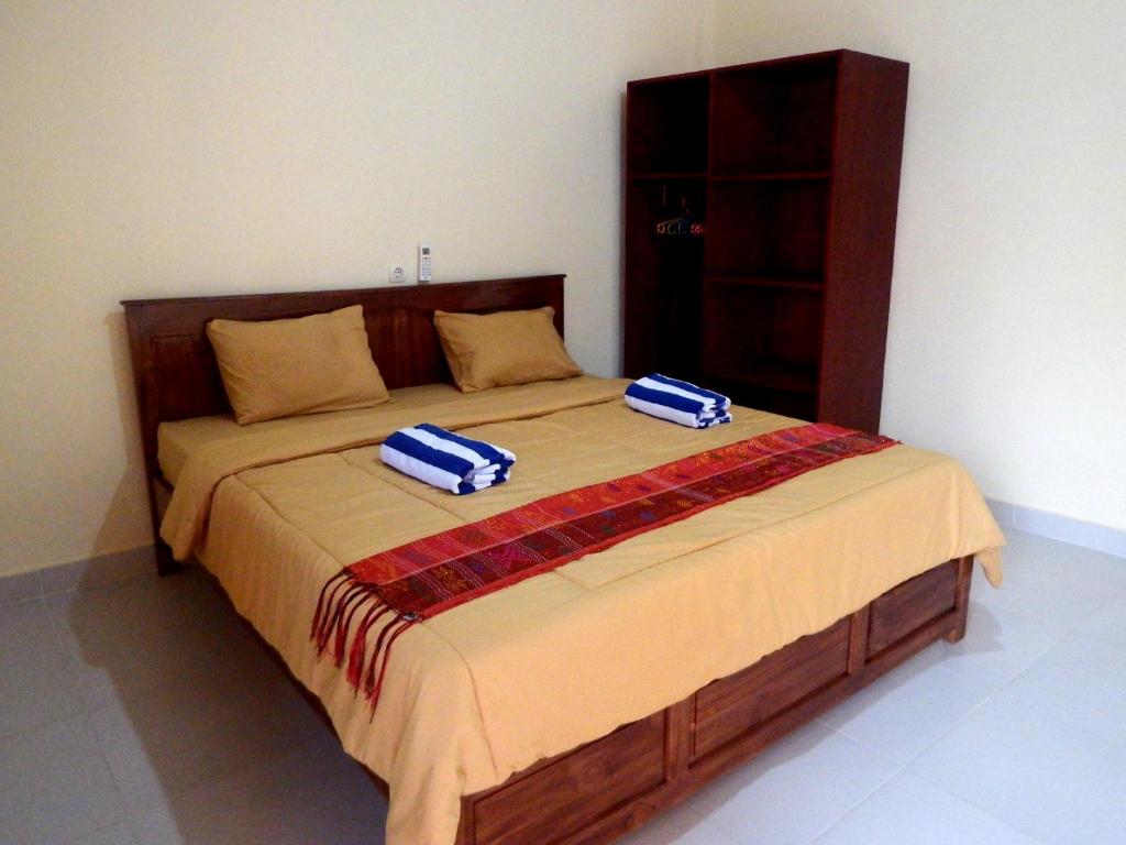 Duas toalhas estão sentadas numa cama num quarto em Golo Tango Homestay em Labuan Bajo