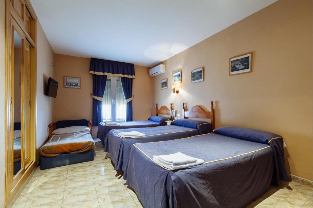 Postel nebo postele na pokoji v ubytování Hotel Philadelfia