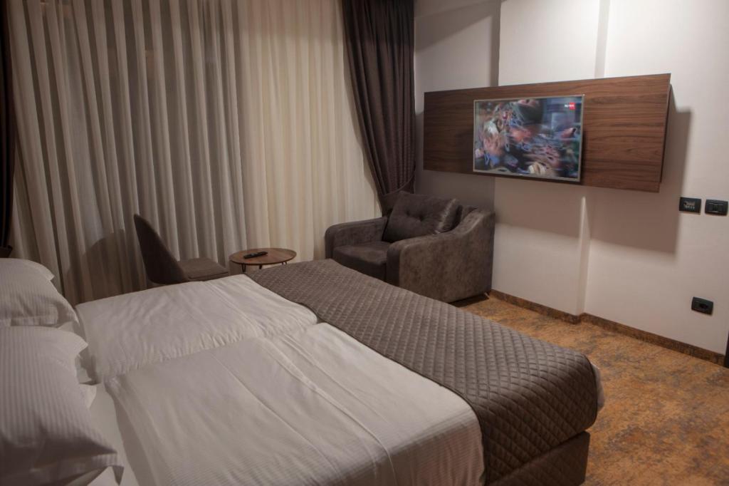 Postel nebo postele na pokoji v ubytování Qama Hotel