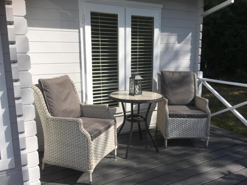 two chairs and a table on a porch at Willow House B&B in West Wittering