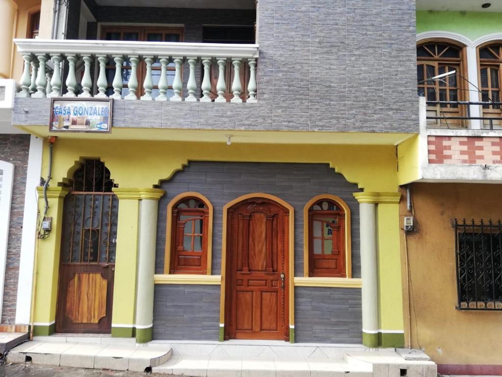 a house with wooden doors and a balcony at Casa González in Santiago Atitlán