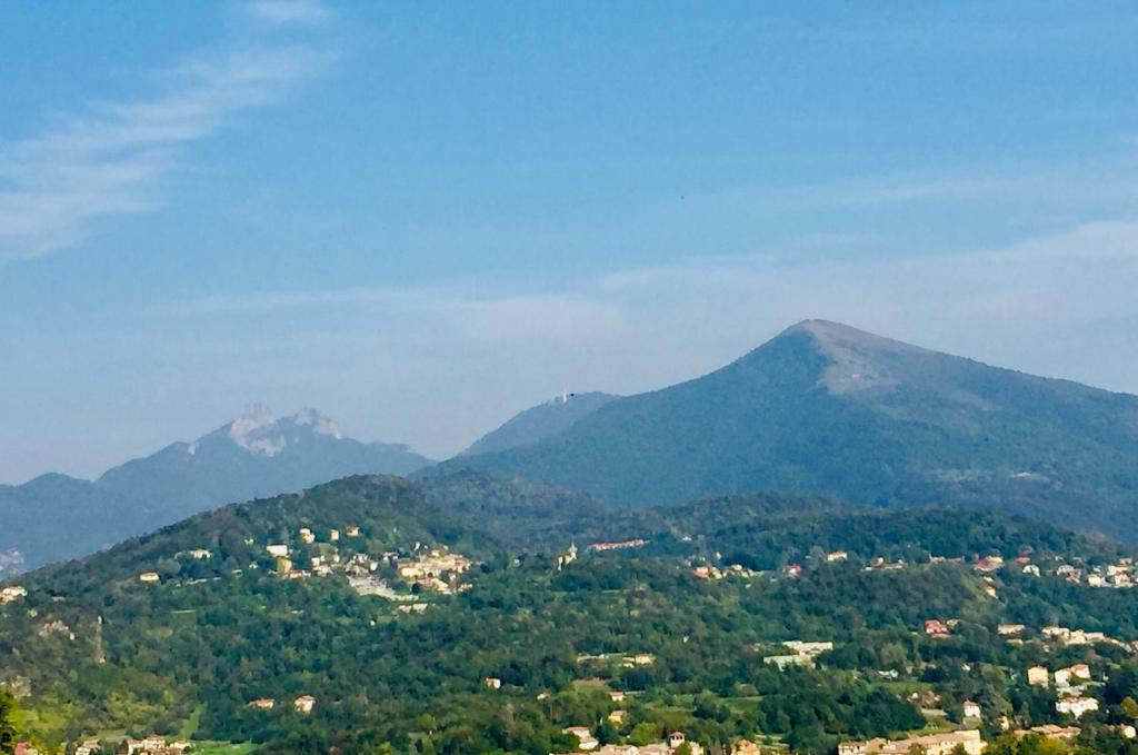 a view of a mountain with a town and mountains at Lakes&Hills Apartments in Erba