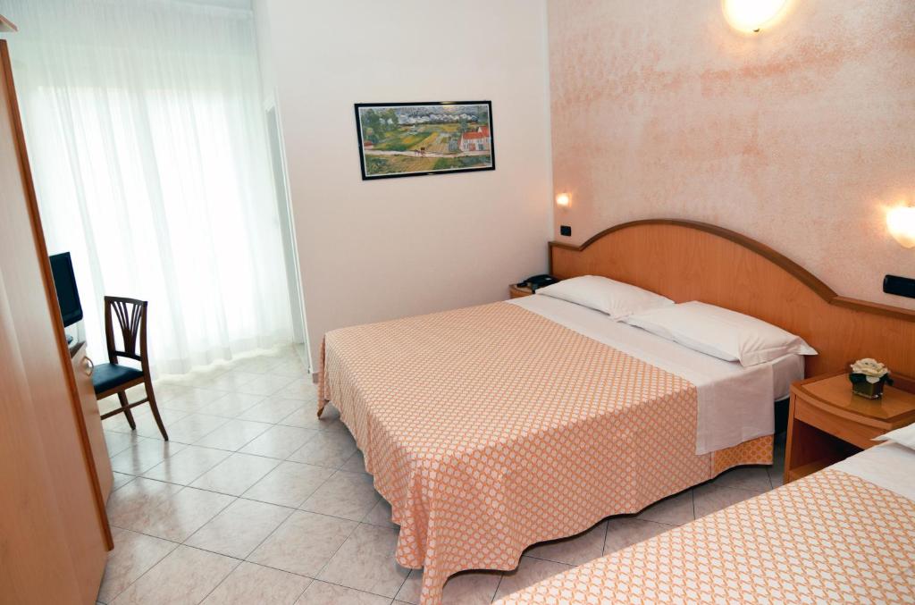 Postel nebo postele na pokoji v ubytování Hotel Adele