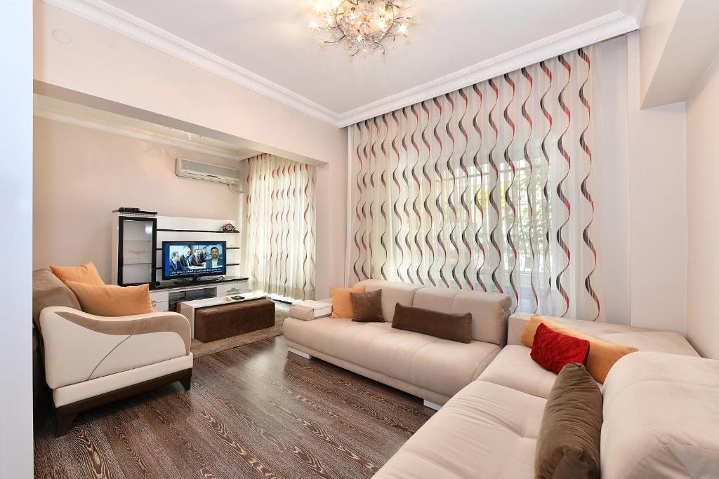 a living room with a couch and a tv at İskete Suit in Istanbul