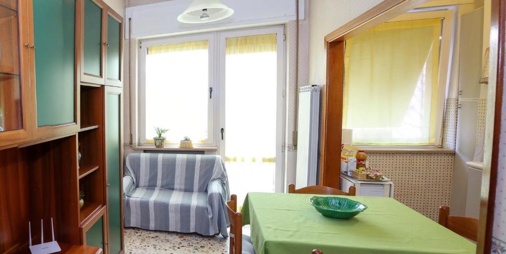 a living room with a green table and a chair at Casa Simo Apartment in Castel di Sangro
