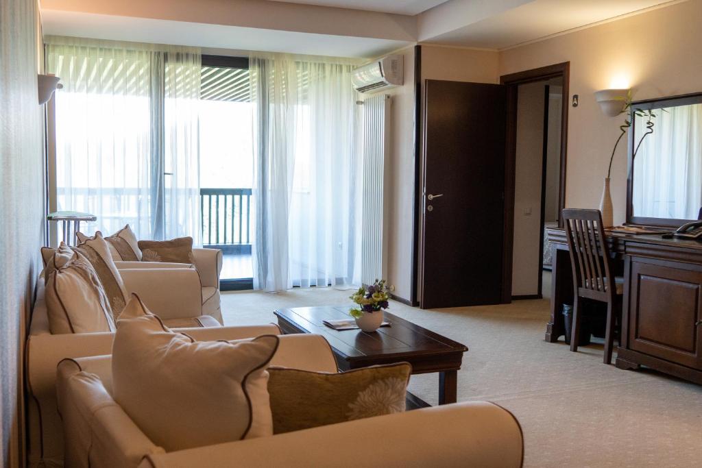a living room with two couches and a television at Apartament executive vedere munte Alpin Resort Poiana Brasov in Poiana Brasov