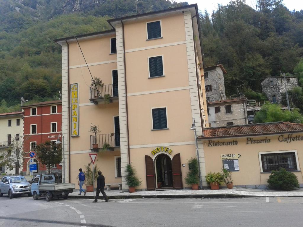 a building on the corner of a street in a town at La Pania in Stazzema