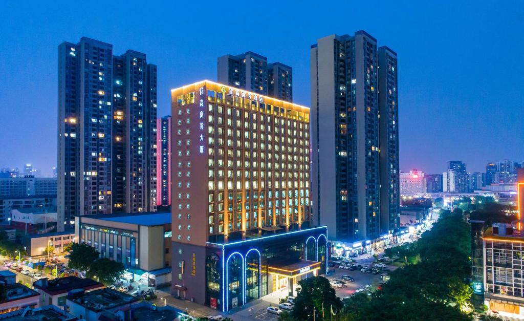 a lit up building in a city at night at Foshan Jiagao Business Hotel in Foshan