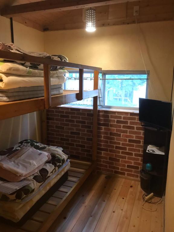 Postel nebo postele na pokoji v ubytování Kumamoto Guesthouse Minami Aso Little Asia