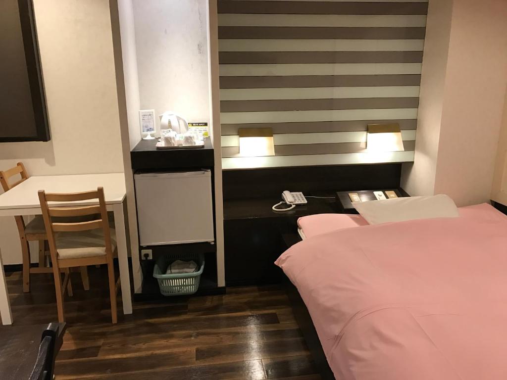 Postel nebo postele na pokoji v ubytování ビジネスインホテルプラザ21大阪京橋
