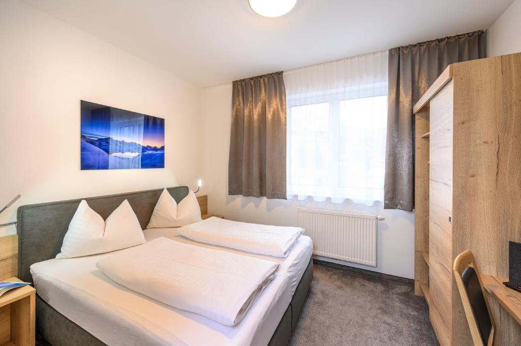 Posteľ alebo postele v izbe v ubytovaní Appartements Insieme