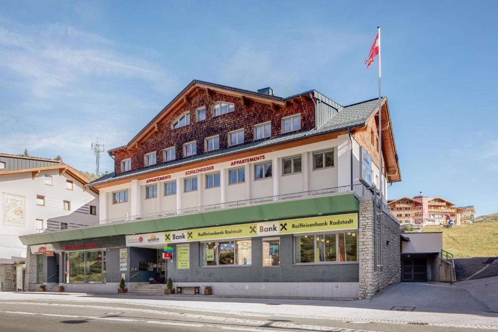 a building on the corner of a street at Appartements Insieme in Obertauern