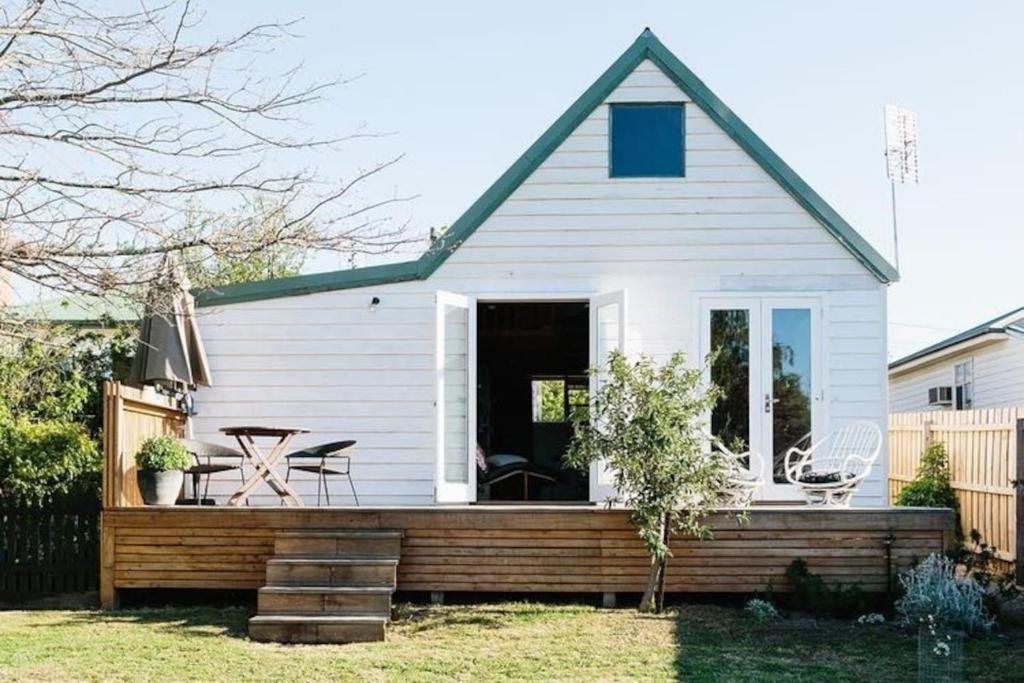 a house with a wooden deck in the yard at Harpsichord House in Kyneton