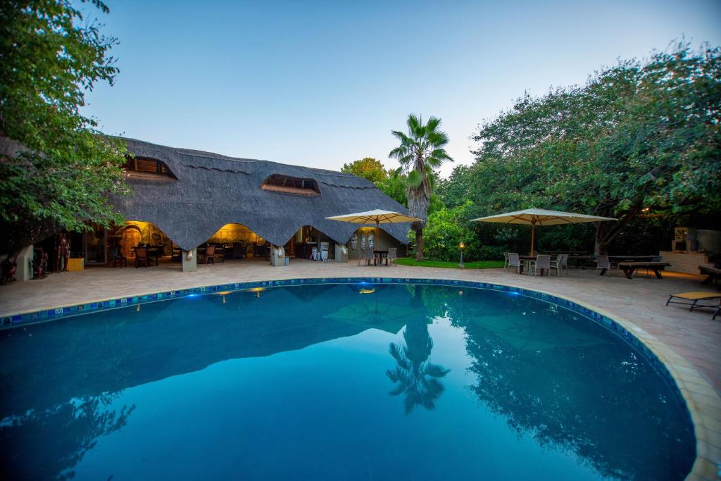 a large swimming pool in a large building at Bayete Guest Lodge in Victoria Falls