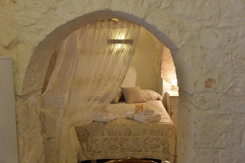 Postel nebo postele na pokoji v ubytování I Trulli Del Nonno Michele