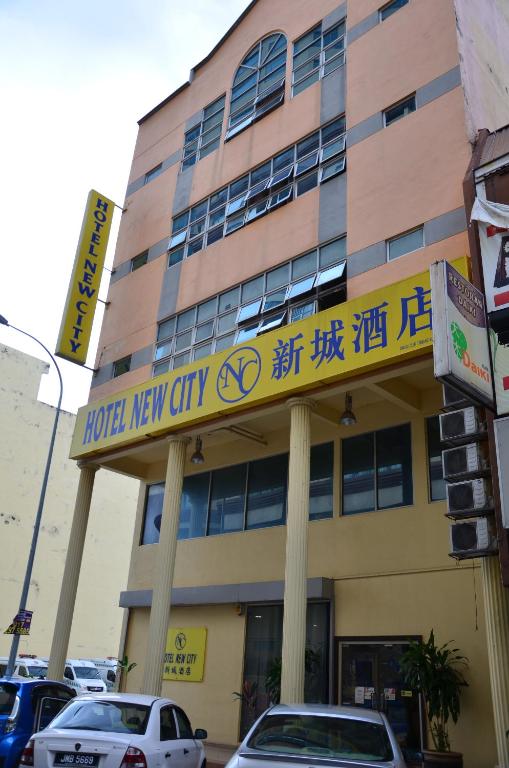 a building with a sign for a hotel new city at New City Hotel in Kajang