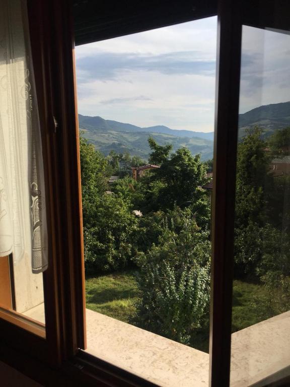 a view from a window looking out at the countryside at Casa Belvedere in Lizzano in Belvedere