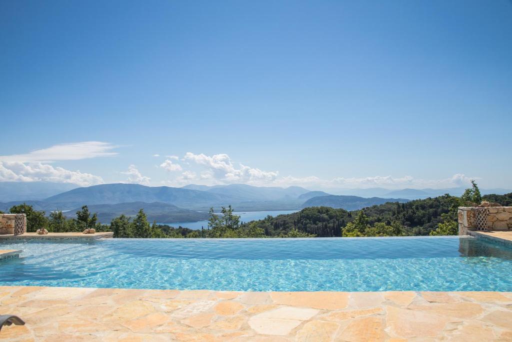 a swimming pool with a view of the mountains at Villa Venetia Corfu in Agnítsini