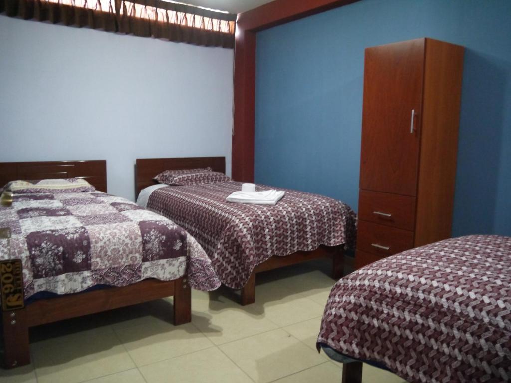 Postel nebo postele na pokoji v ubytování Hotel Suite Juliaca