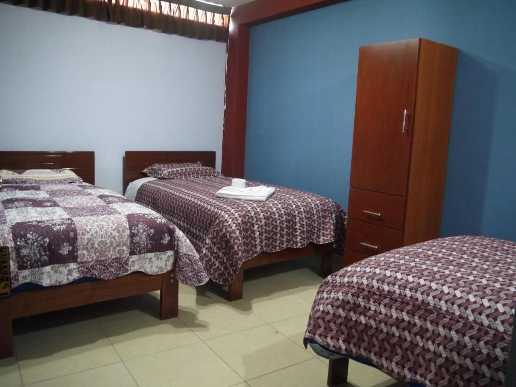 Postel nebo postele na pokoji v ubytování Hotel Suite Juliaca