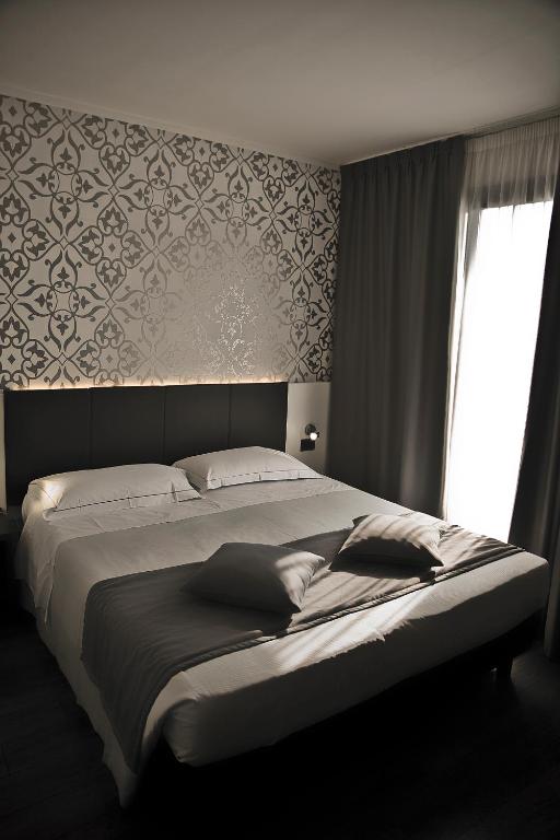 Łóżko lub łóżka w pokoju w obiekcie Ilga Hotel