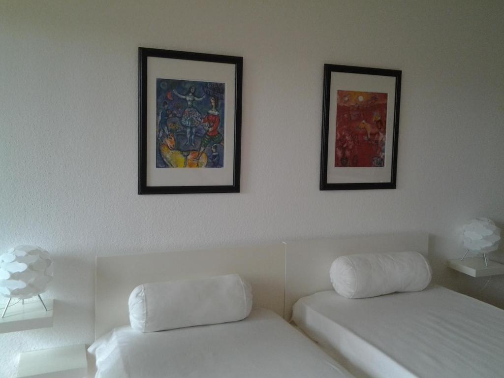 a room with two beds and two pictures on the wall at Wohlfühl Appartment Braunlage in Braunlage