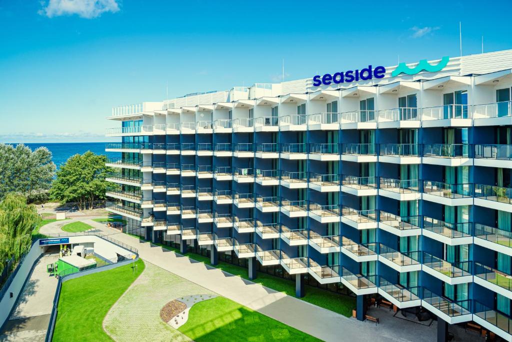 an aerial view of a building with the ocean in the background at Seaside Park Hotel in Kołobrzeg