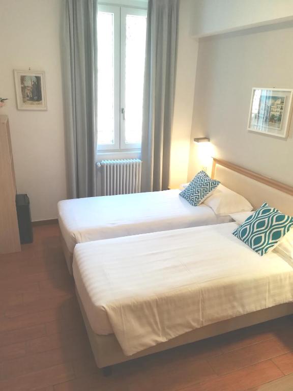 Postel nebo postele na pokoji v ubytování Hotel Quarcino