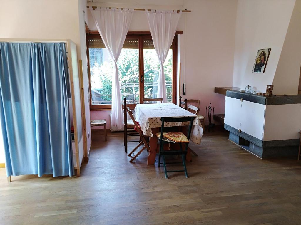 ein Esszimmer mit einem Tisch, Stühlen und einem Fenster in der Unterkunft Le Piagge in Nemi