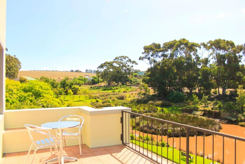 a balcony with a table and chairs and a view at Peace Valley Guesthouse in Napier